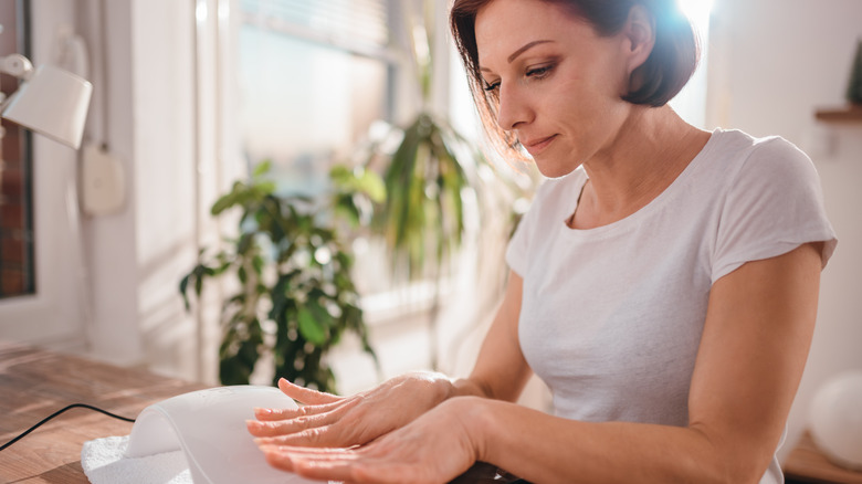 woman looking at horizontal lines on fingers