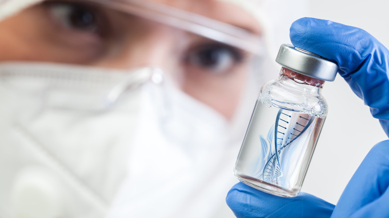 Scientist holding bottle of vaccine 