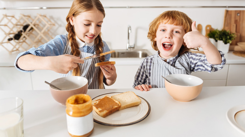 Kids making peanut butter sandwiches