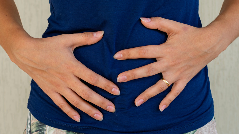 A woman holding her stomach