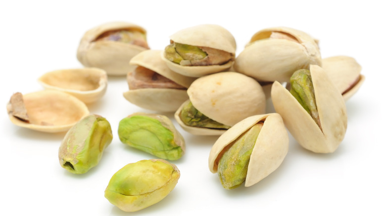 handful of pistachios on a white background