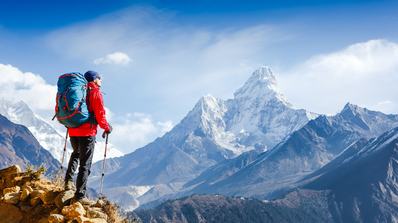 A man summits a large mountain