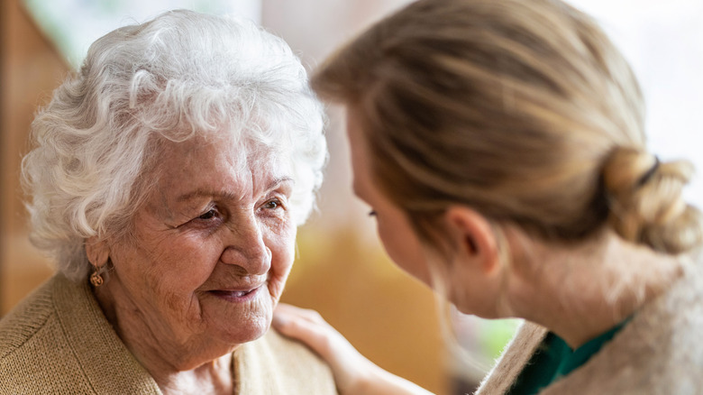 older adult speaking to younger adult