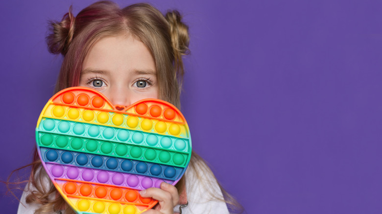 girl with multicolored sensory toy