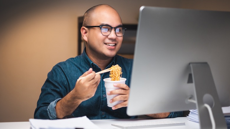 Man eating instant ramen