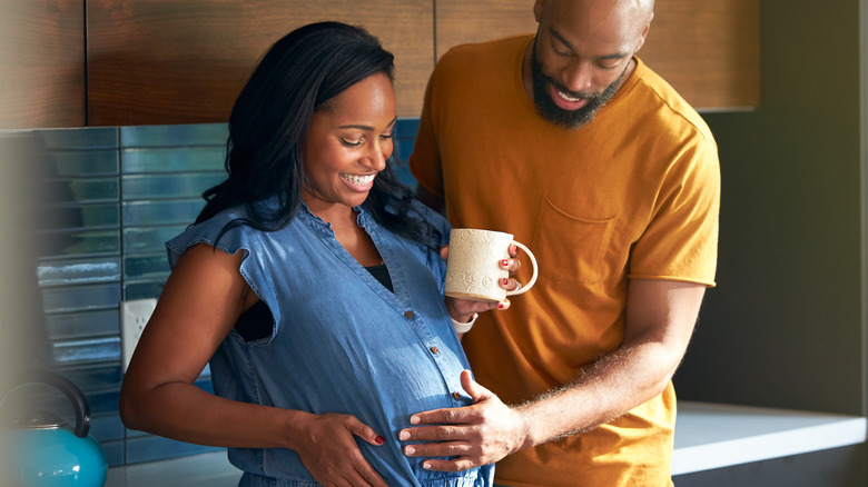 Couple looking at baby bump