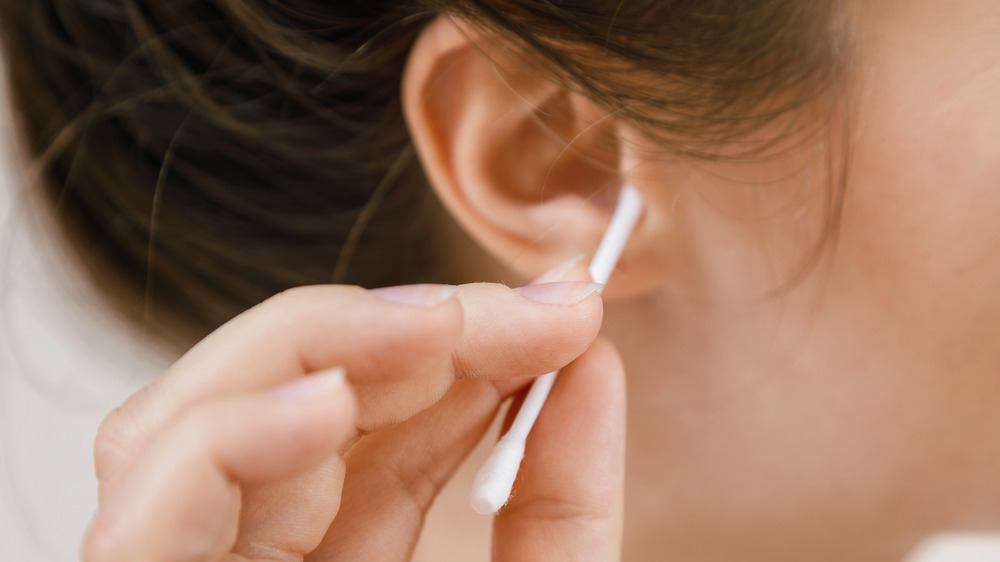 close up of a woman swabbing her ear