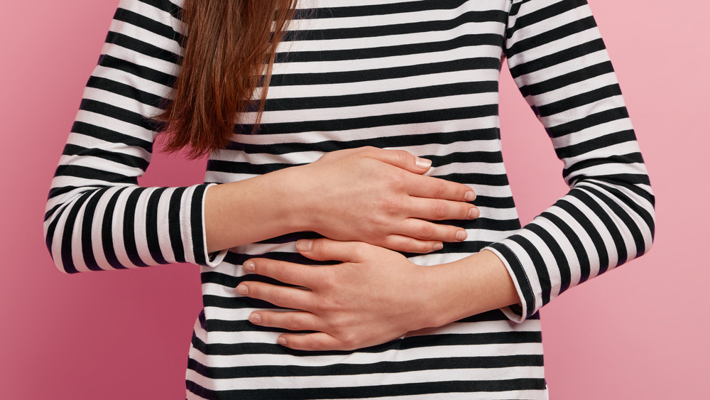 Close up of a woman's arms crossed over her stomach