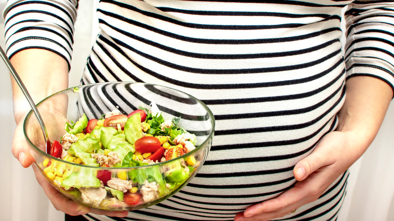 Pregnant woman eating tuna salad
