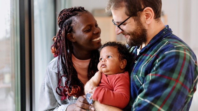 happy young parents with infant