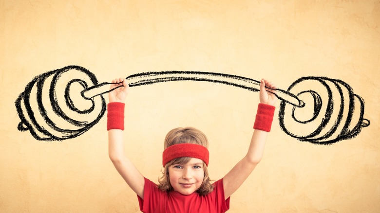 kid with cartoon weights drawn overhead 