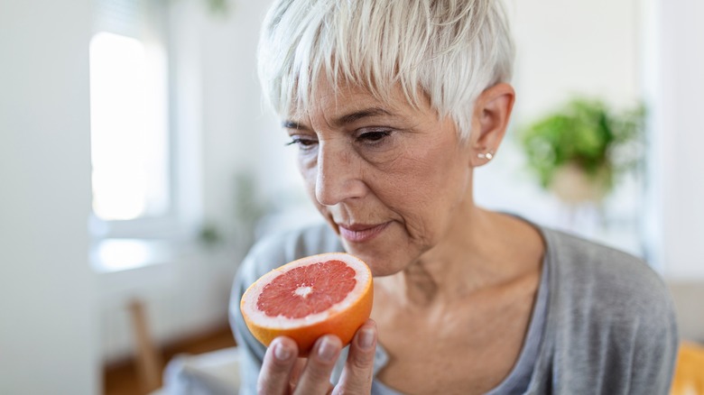 Woman sniffing orange