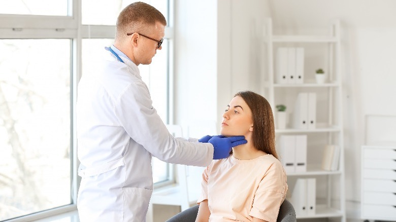 doctor examines for tumor or cyst