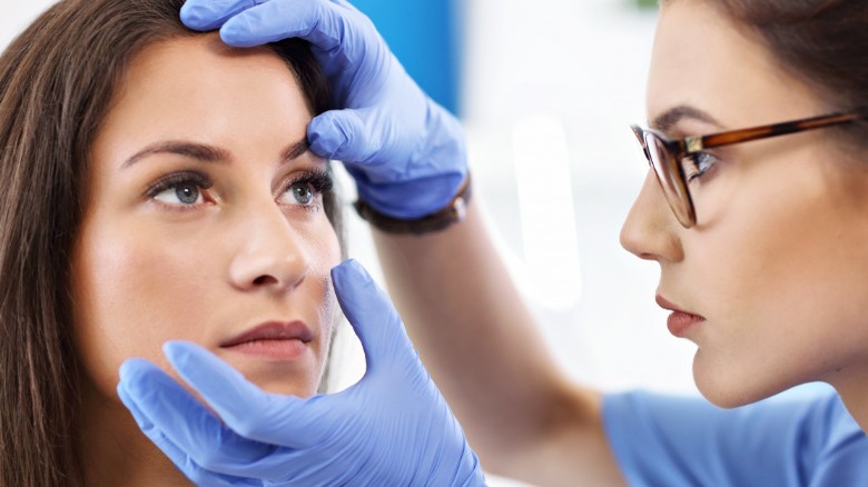 eye doctor examines patient