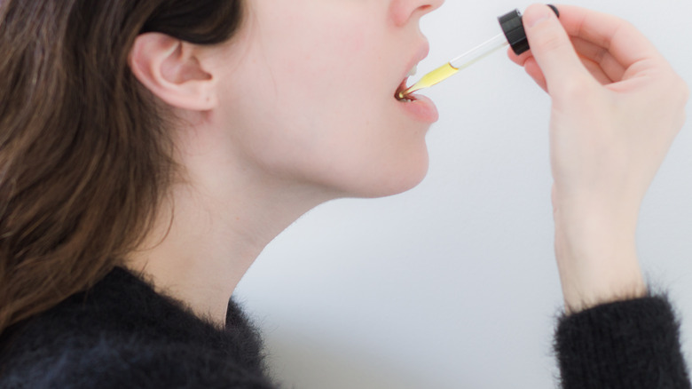 Woman taking CBD oil