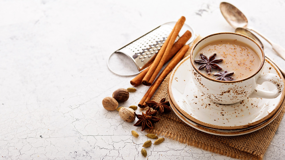 A cup of chai tea and cinnamon sticks