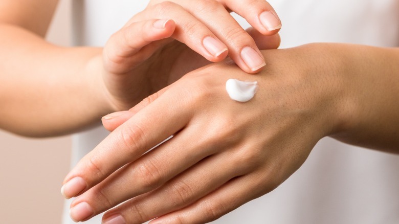 woman applying hand cream
