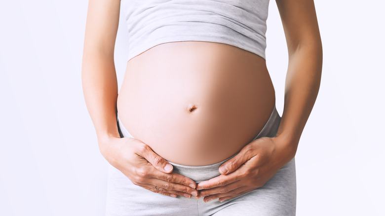 pregnant woman eating jar
