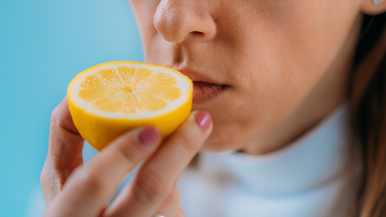 Person sniffing lemon
