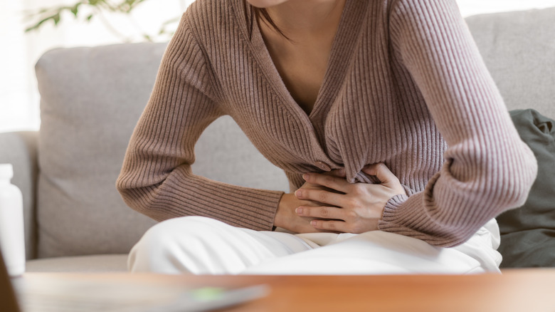 woman holding stomach