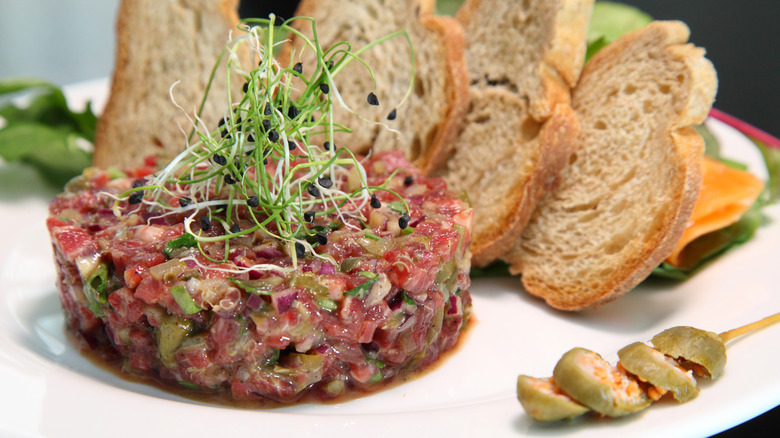 A steak tartare dish with bread