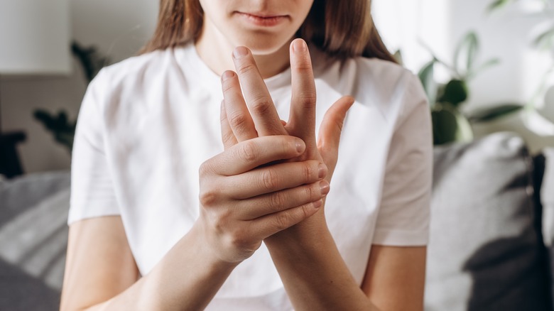 woman holding wrists