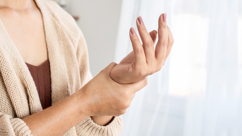 woman holding wrists