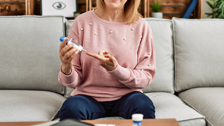 woman using glucometer 