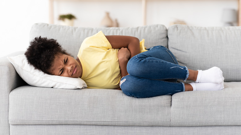 Girl on couch in pain