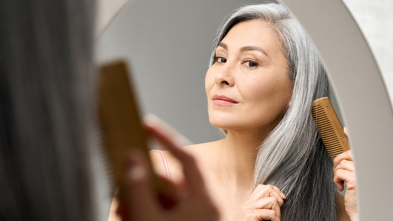 middle aged woman brushing her hair