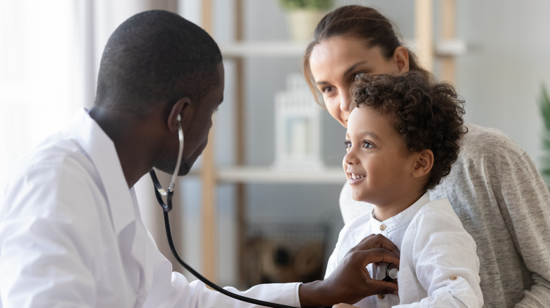 Using a stethoscope on a patient