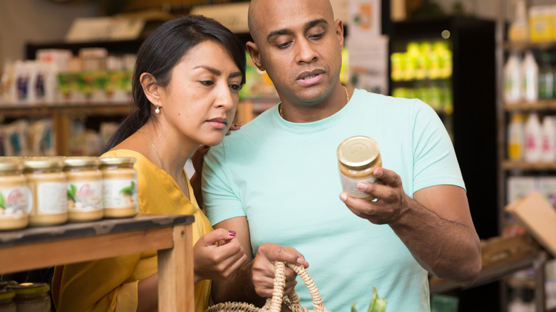 couple reading label on jar