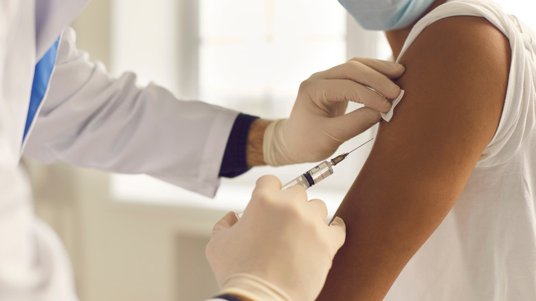 Medical professional giving person shot