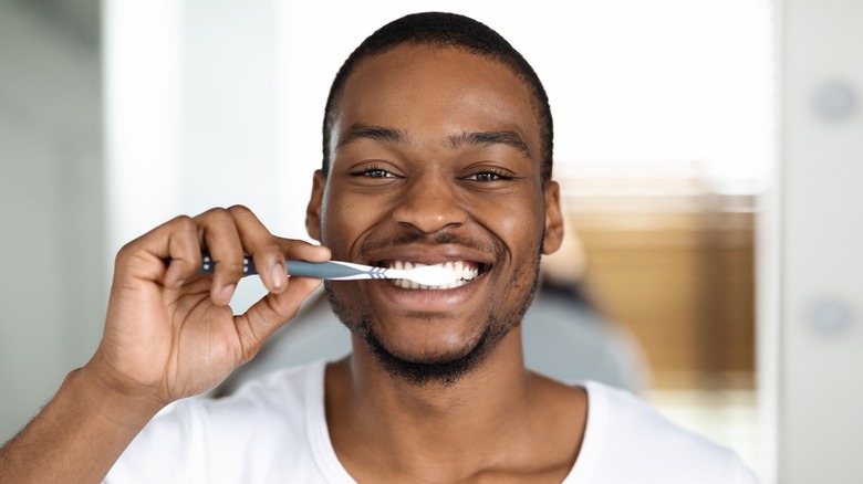 man brushing teeth