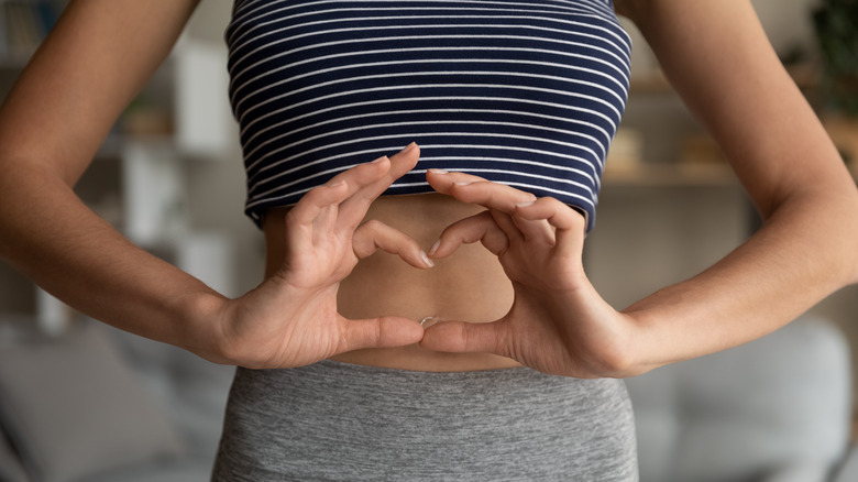 woman making heart sign with hands