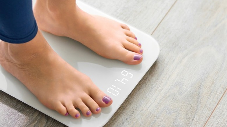 Woman standing on scale