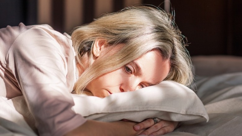 Woman struggling to fall asleep