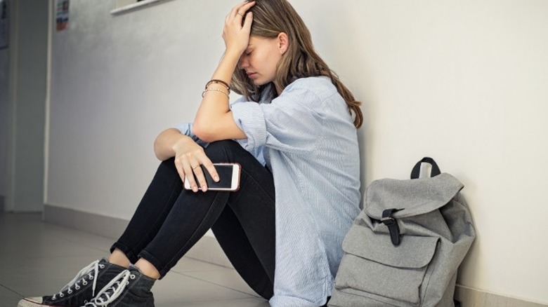 Woman sitting on floor alone
