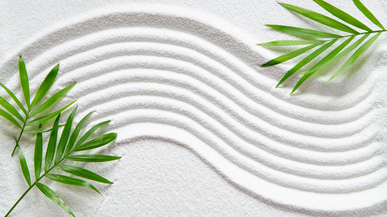 zen pattern white sand palm leaves