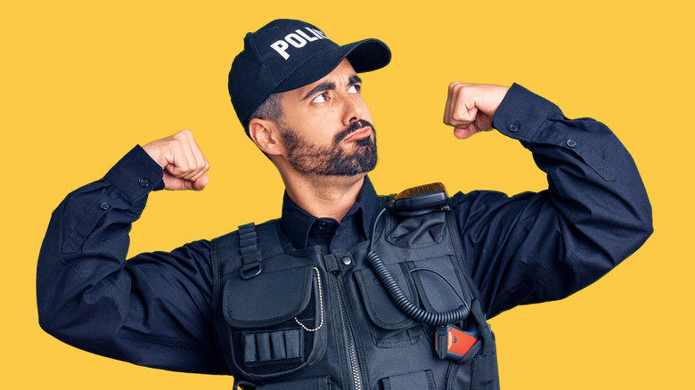 policeman flexing muscles