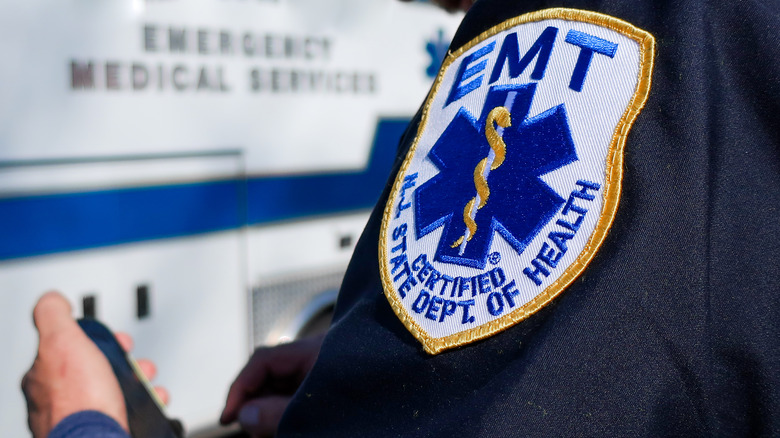 Close-up of a person's EMT shoulder badge