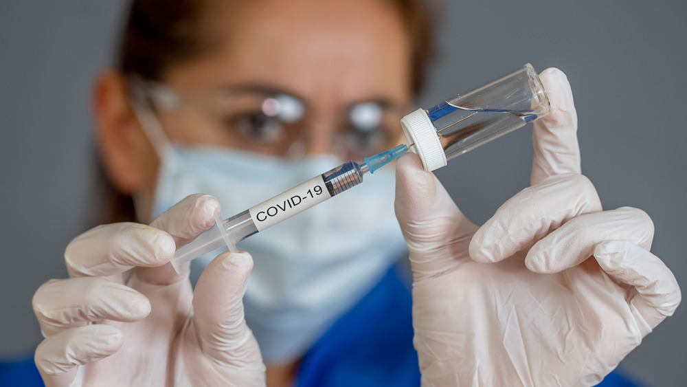 Medical worker filling COVID-19 vaccination