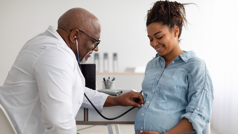 Doctor examining pregnant woman