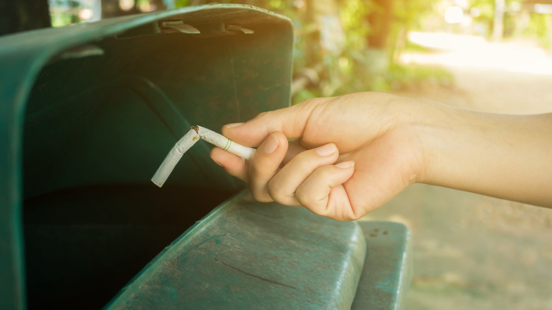 woman throwing away cigarette