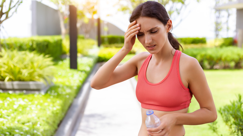 woman in running outfit suffering from heat
