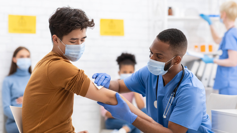 medical professional administering COVID vaccine