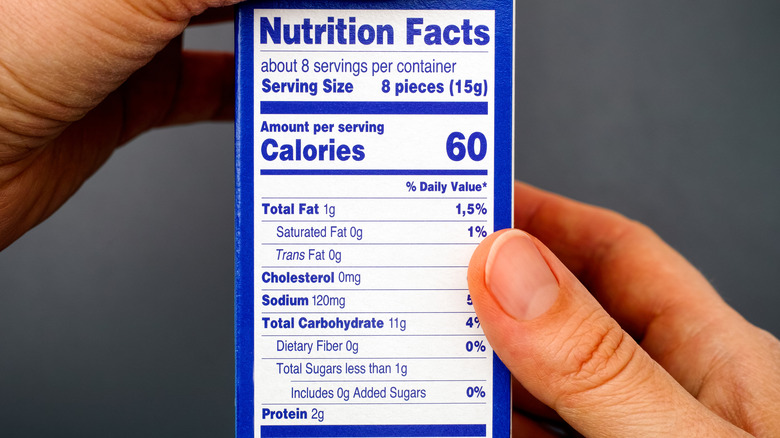 hands holding nutrition label