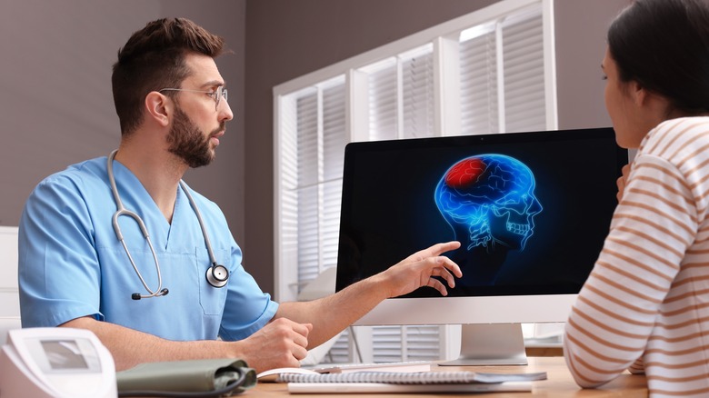 doctor examining computerized brain scan