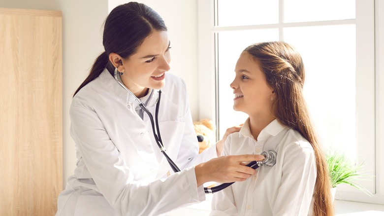 doctor examining patient's heart