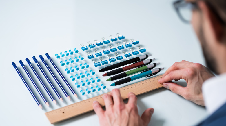 man rearranging pencils ocd